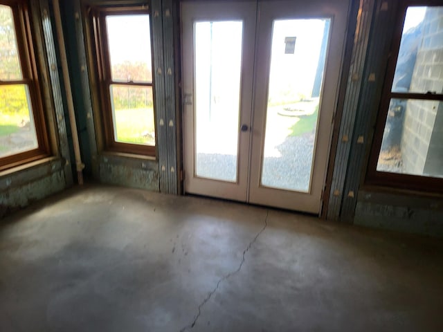 interior space with concrete floors and french doors