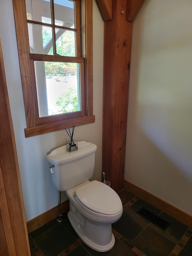 bathroom featuring toilet and tile patterned flooring