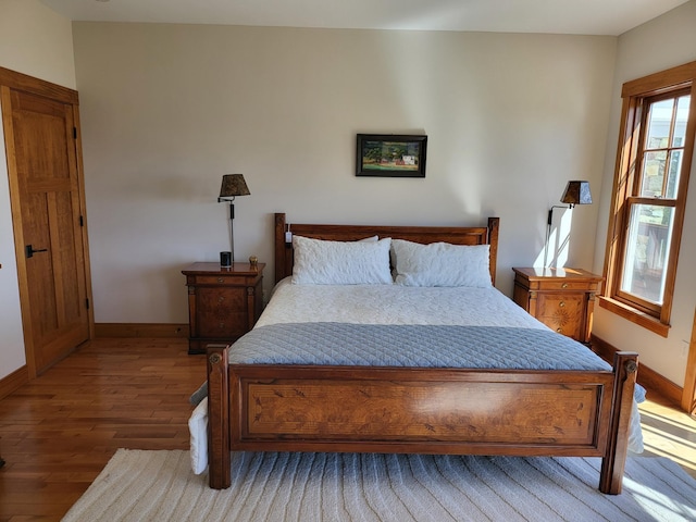 bedroom with hardwood / wood-style floors