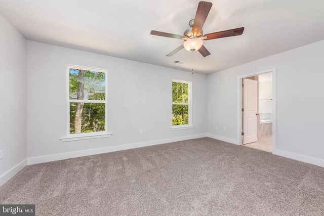 carpeted spare room with ceiling fan