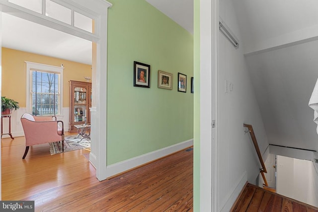 corridor with hardwood / wood-style flooring