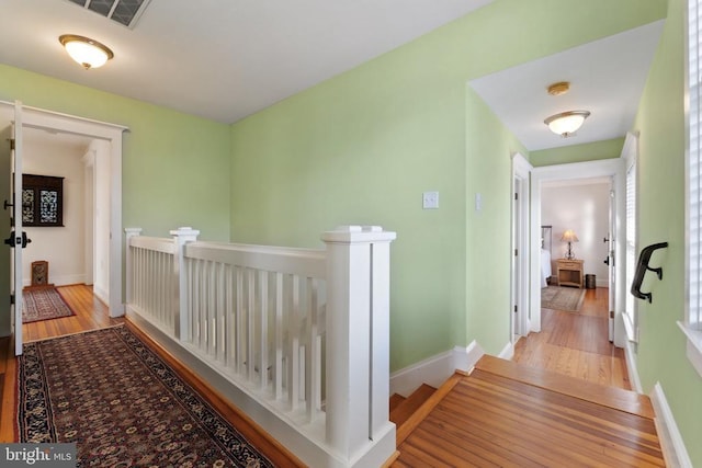 corridor with light hardwood / wood-style floors