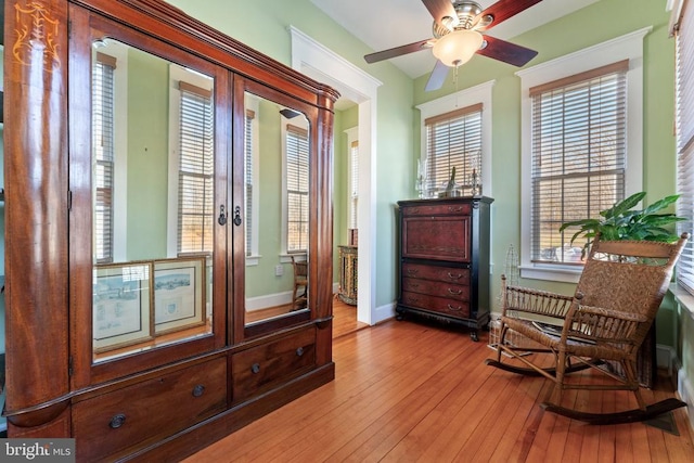 sitting room with ceiling fan, plenty of natural light, and light hardwood / wood-style floors