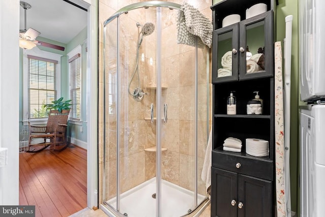 bathroom with hardwood / wood-style floors and walk in shower