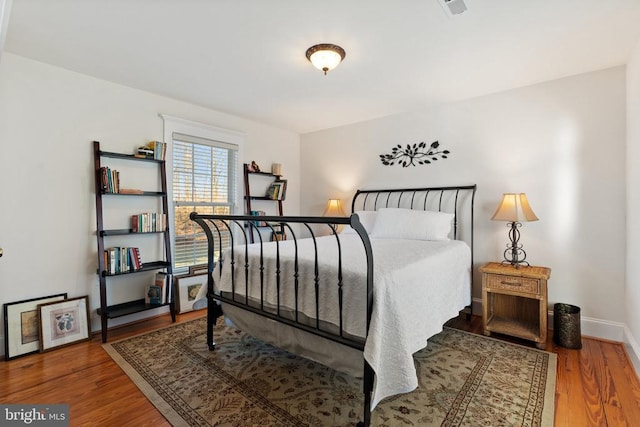 bedroom with wood-type flooring