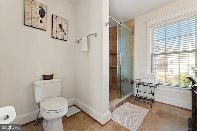 bathroom featuring an enclosed shower and toilet