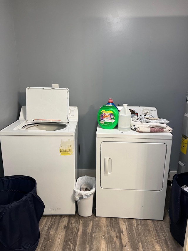 laundry area with washing machine and dryer and dark hardwood / wood-style floors