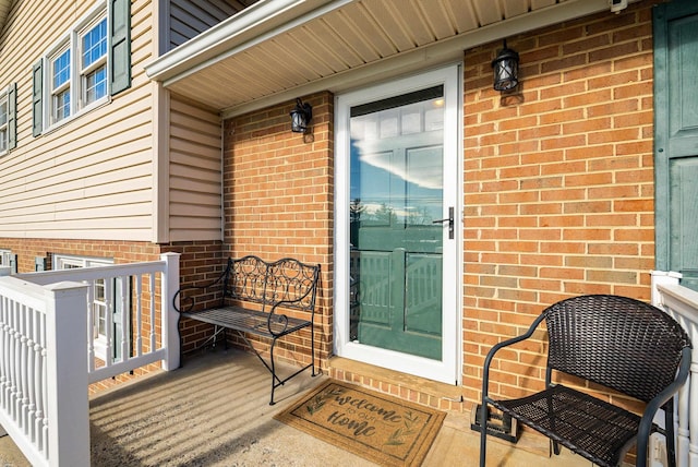 view of exterior entry with brick siding