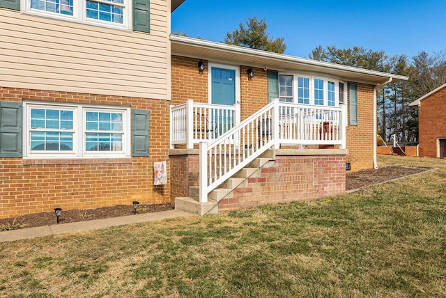 exterior space featuring a front yard and brick siding