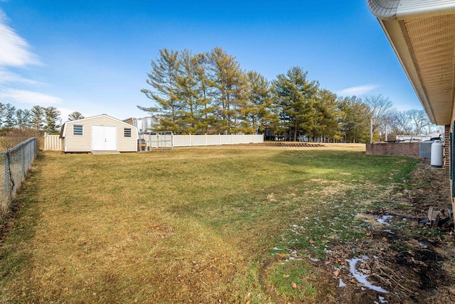 view of yard with a fenced backyard, an outbuilding, and a shed