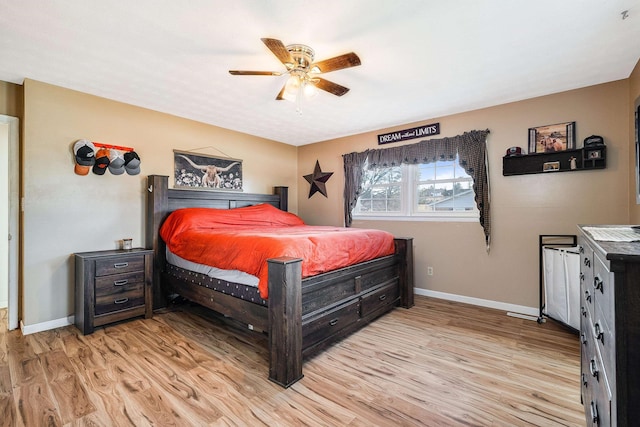 bedroom with light wood-type flooring, ceiling fan, and baseboards