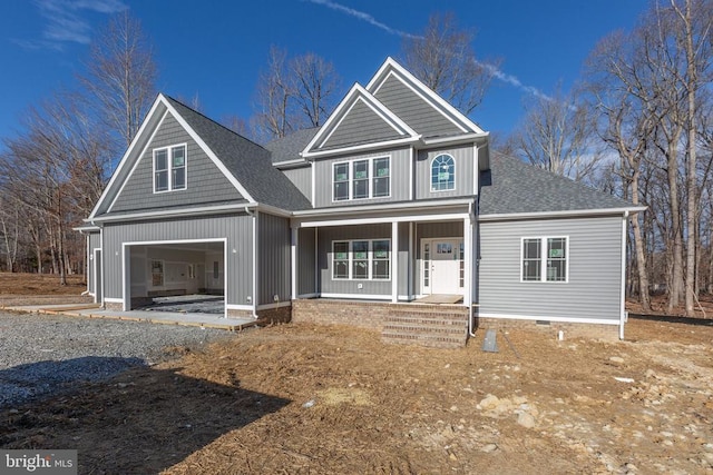 view of front facade featuring a porch, roof with shingles, driveway, and board and batten siding