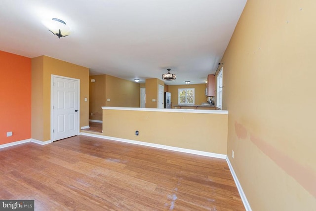 empty room with light hardwood / wood-style flooring