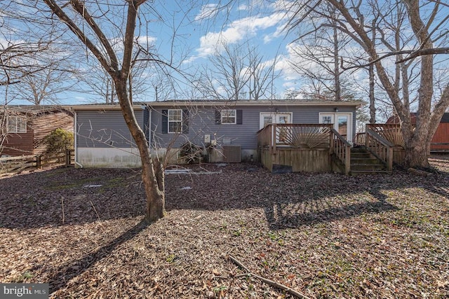 view of front of house with cooling unit and a deck