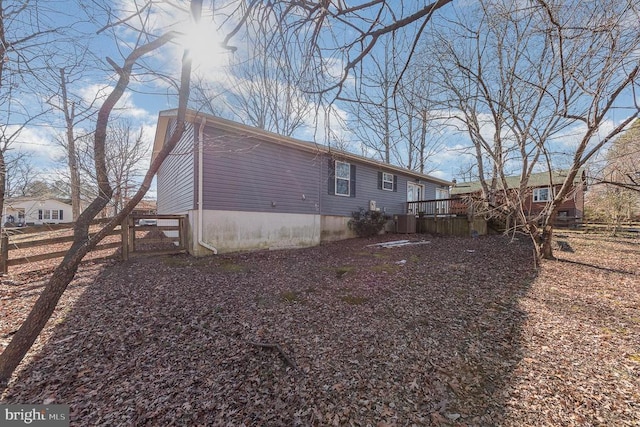 view of property exterior featuring a deck