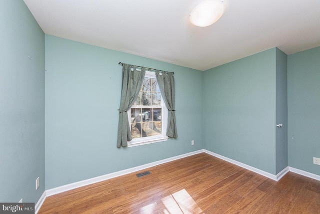 empty room featuring wood-type flooring