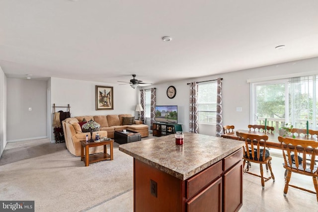kitchen with a kitchen island, a ceiling fan, and open floor plan