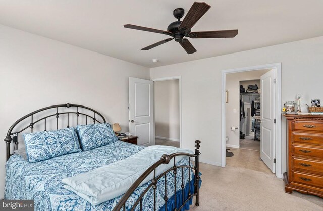 bedroom featuring light colored carpet, baseboards, and ceiling fan