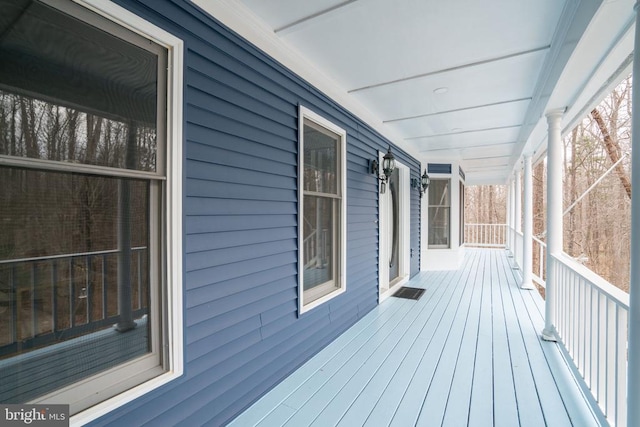 wooden terrace featuring covered porch