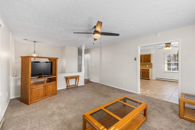 living room with a baseboard radiator, a textured ceiling, light colored carpet, and ceiling fan