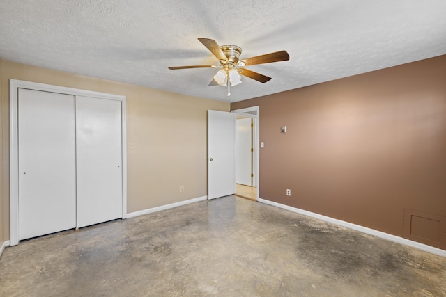 unfurnished bedroom featuring a textured ceiling, a closet, ceiling fan, and concrete floors