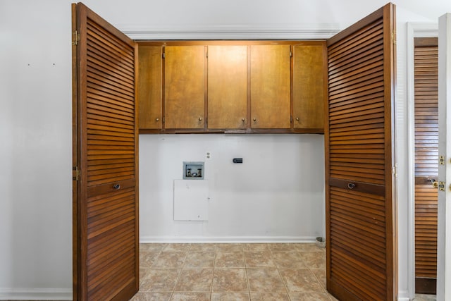 laundry area featuring cabinets, hookup for an electric dryer, washer hookup, and light tile patterned flooring