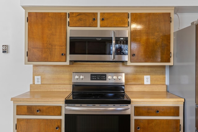 kitchen with appliances with stainless steel finishes and tasteful backsplash