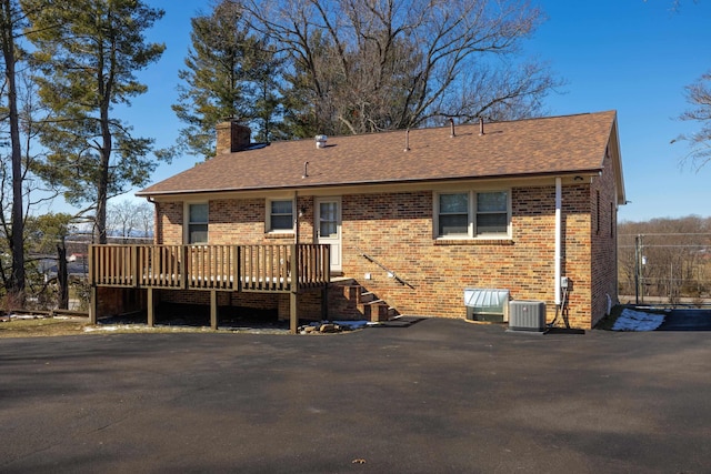 back of property featuring central AC and a wooden deck