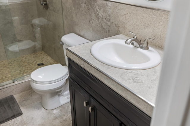 bathroom featuring vanity, toilet, and a shower with shower door