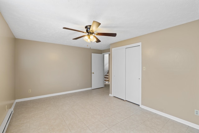 unfurnished bedroom featuring a closet, ceiling fan, a baseboard heating unit, and a textured ceiling