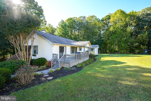 view of front facade featuring a deck, a chimney, and a front lawn