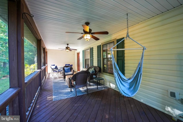 deck featuring ceiling fan and an outdoor living space