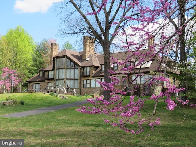 rear view of house with a yard