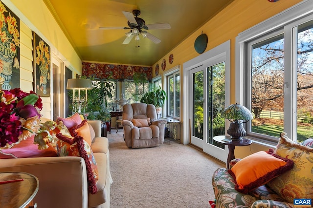 sunroom featuring a healthy amount of sunlight and ceiling fan