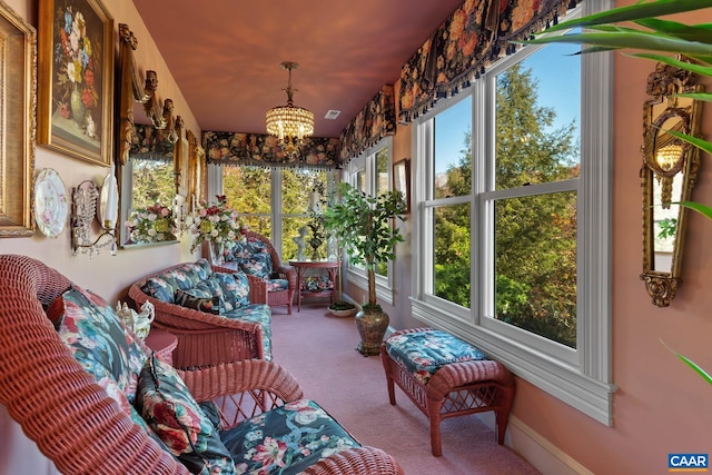 sunroom featuring a chandelier