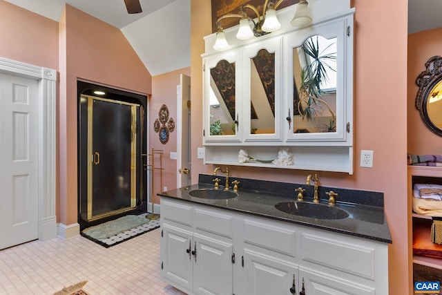 bathroom featuring an enclosed shower, vanity, and vaulted ceiling