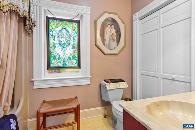 bathroom featuring vanity, toilet, and tile patterned flooring