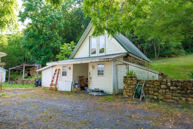 exterior space with an outbuilding and a carport