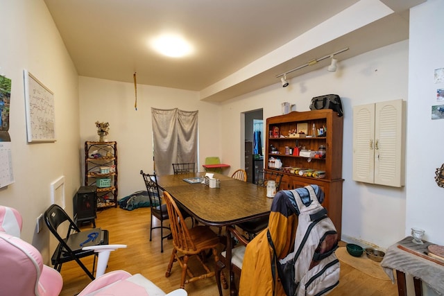 dining area featuring light hardwood / wood-style flooring and track lighting