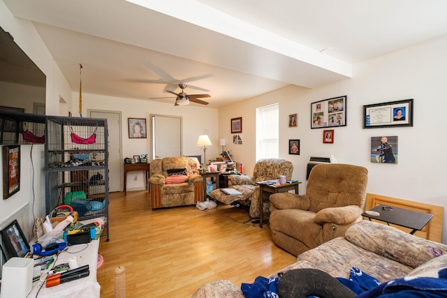 living room with ceiling fan and light hardwood / wood-style floors