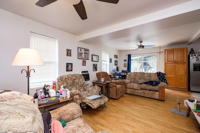 living room featuring light hardwood / wood-style flooring and ceiling fan