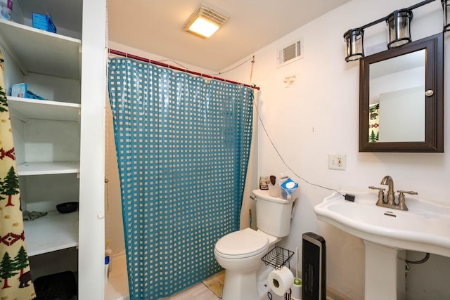 bathroom with sink, toilet, and walk in shower