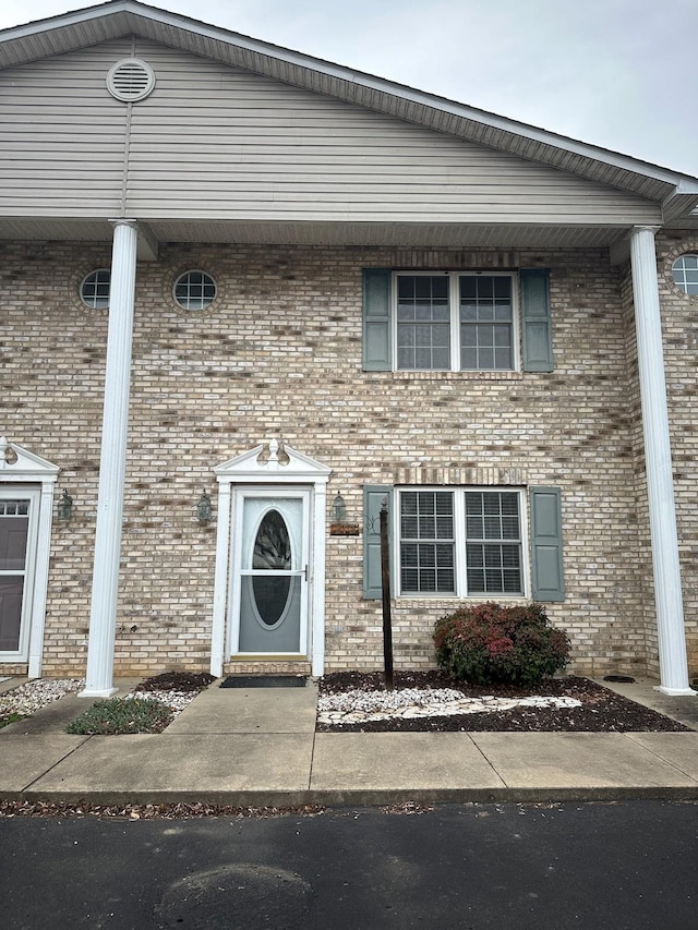 view of front of home featuring brick siding