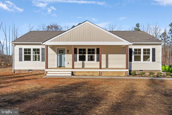 ranch-style house featuring covered porch