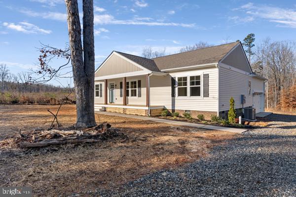 single story home featuring a porch and a garage