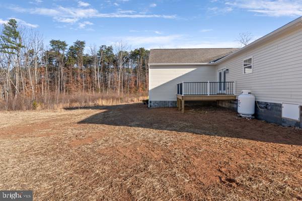 view of side of home with a wooden deck