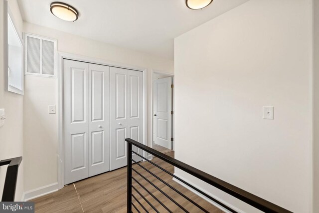 hall with light hardwood / wood-style floors