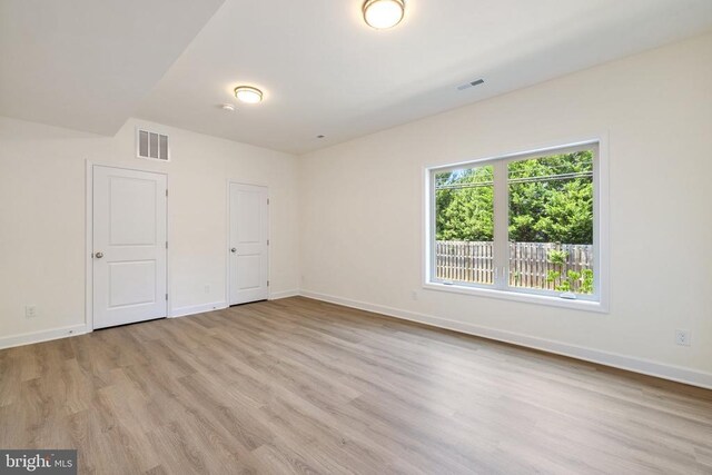 spare room featuring light wood-type flooring