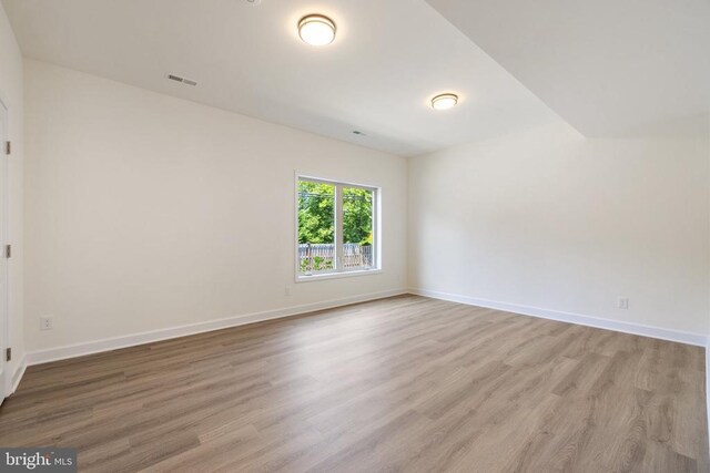 unfurnished room with light wood-type flooring