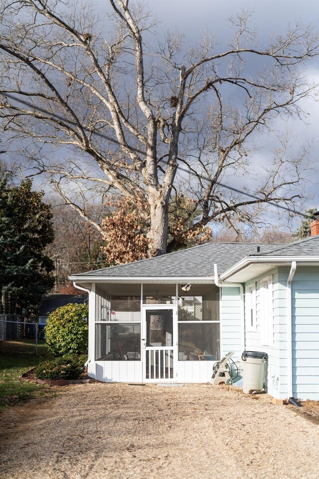 rear view of property with a sunroom